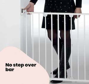 Mother using baby gate for top of the stairs