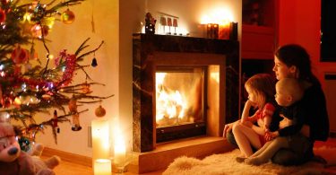 Baby proof fireplace: A family cuddling in front of a warm fire