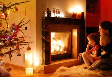 Baby proof fireplace: A family cuddling in front of a warm fire