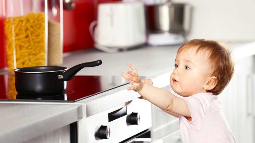 Baby reaching for pan: Childproofing your kitchen