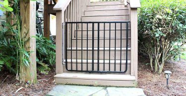 Outdoor baby gate: black gate at foot of stairs