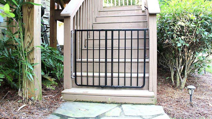 Outdoor baby gate: black gate at foot of stairs