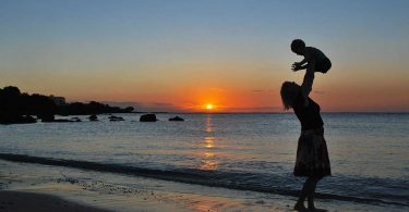 Traveling with baby: A mother and baby at sunset