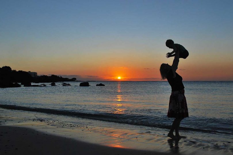 Traveling with baby: A mother and baby at sunset