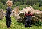 Camping with a baby: two young children playing in the countryside